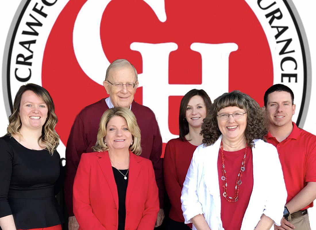 About Our Agency - Crawford-Henderson Insurance Team Together with the Logo Behind Them